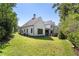 White two-story house with gray roof, landscaping and a large backyard at 464 Pine Tree Ne Dr, Atlanta, GA 30305