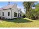 White two-story house with gray roof, landscaping and a large backyard at 464 Pine Tree Ne Dr, Atlanta, GA 30305