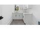 Bright laundry room with white cabinets and quartz countertops at 464 Pine Tree Ne Dr, Atlanta, GA 30305