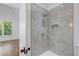 Bright bathroom with a large walk-in shower and gray marble tile at 464 Pine Tree Ne Dr, Atlanta, GA 30305