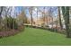 Private backyard with a grassy area and mature trees at 4450 Fairfax Dr, Cumming, GA 30028