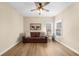 Cozy bedroom with hardwood floors and brown leather sofa at 4450 Fairfax Dr, Cumming, GA 30028