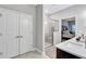 Bright bathroom offering vanity with sink and shower behind glass doors and a bedroom glimpsed beyond at 532 Barlow Pl, Grayson, GA 30017