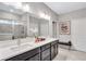 Modern bathroom with a double vanity, large mirror, and a tiled shower with glass door at 532 Barlow Pl, Grayson, GA 30017