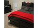 Guest bedroom with a black platform bed and red blanket at 532 Barlow Pl, Grayson, GA 30017