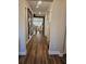 Bright and spacious hallway with wood-look flooring and modern wall art at 532 Barlow Pl, Grayson, GA 30017