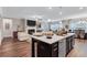 Modern open concept kitchen with large island, stainless appliances, and seamless living area at 532 Barlow Pl, Grayson, GA 30017