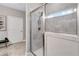 Stylish shower enclosed by glass featuring neutral tile, overhead lighting, and a clear view outside at 532 Barlow Pl, Grayson, GA 30017