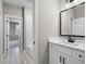 Modern bathroom with white vanity, patterned tile floor, and a shower at 208 Pindos Sw Pl, Powder Springs, GA 30127