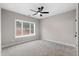 Well-lit bedroom with carpet flooring and a large window at 208 Pindos Sw Pl, Powder Springs, GA 30127