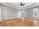 Bright and airy bedroom with hardwood floors and a ceiling fan at 208 Pindos Sw Pl, Powder Springs, GA 30127