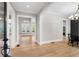 Bright entryway with hardwood floors, a view into the living room and dining area at 208 Pindos Sw Pl, Powder Springs, GA 30127