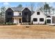 Stunning two-story farmhouse with white and black exterior, landscaping, and attached garage at 208 Pindos Sw Pl, Powder Springs, GA 30127