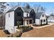 Two-story farmhouse-style home with white and black exterior at 208 Pindos Sw Pl, Powder Springs, GA 30127