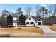 A modern farmhouse with white and black exterior and landscaping at 208 Pindos Sw Pl, Powder Springs, GA 30127