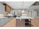 Modern kitchen with large island, gray cabinets, and wood accents at 208 Pindos Sw Pl, Powder Springs, GA 30127