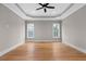 Main bedroom with hardwood floors and tray ceiling at 208 Pindos Sw Pl, Powder Springs, GA 30127