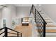 Modern staircase overlooking the kitchen and living area at 208 Pindos Sw Pl, Powder Springs, GA 30127