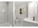 Updated bathroom features a walk-in shower, white vanity, and marble tile at 2212 Glendale Dr, Decatur, GA 30032