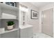 Updated bathroom with white vanity, tiled floors, and open shelving at 2212 Glendale Dr, Decatur, GA 30032