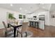 Modern kitchen with white cabinets, stainless steel appliances, and breakfast bar at 2212 Glendale Dr, Decatur, GA 30032