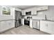 Modern kitchen with white shaker cabinets, granite counters, and stainless steel appliances at 2212 Glendale Dr, Decatur, GA 30032