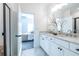 Double vanity bathroom with white cabinets and a view into a bedroom at 2487 Figaro Dr, Atlanta, GA 30339