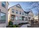 Three story townhouses with brick facade and front porches at 2487 Figaro Dr, Atlanta, GA 30339