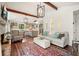 Open living room featuring hardwood floors, a stone fireplace, and a view into the kitchen at 2671 Caldwell Ne Rd, Brookhaven, GA 30319