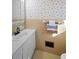 Small bathroom with yellow tile, a white vanity, and a medicine cabinet at 2833 Alan Sw Dr, Marietta, GA 30064