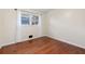 Simple bedroom with hardwood floors and large window at 2833 Alan Sw Dr, Marietta, GA 30064