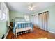 Bedroom with hardwood floors, light green walls, and a vintage bed frame at 2833 Alan Sw Dr, Marietta, GA 30064