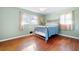 Light green bedroom with hardwood floors and a vintage metal bed at 2833 Alan Sw Dr, Marietta, GA 30064