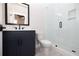 Modern bathroom with dark vanity, glass shower, and white toilet at 530 Fisher Dr # 45, Alpharetta, GA 30009