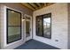 Private deck with gray siding, black windows and white door at 530 Fisher Dr # 45, Alpharetta, GA 30009