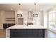 Modern kitchen island with white quartz countertop and dark gray cabinets at 530 Fisher Dr # 45, Alpharetta, GA 30009