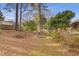 Backyard with firepit and mature landscaping at 5662 Grist Stone Sw Dr, Lilburn, GA 30047