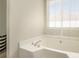 Bathroom with a large garden tub and a window at 1246 Carriage Trace Cir, Stone Mountain, GA 30087