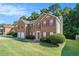 Brick two-story home with a two-car garage and manicured lawn at 1246 Carriage Trace Cir, Stone Mountain, GA 30087