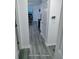 Gray vinyl hallway flooring leading to kitchen and living areas at 1246 Carriage Trace Cir, Stone Mountain, GA 30087