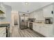 Modern kitchen features stainless steel appliances and white cabinetry at 1246 Carriage Trace Cir, Stone Mountain, GA 30087