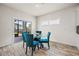 Casual dining area with glass table and four teal chairs, near sliding doors to backyard at 4745 Billow Sw Way, Mableton, GA 30126