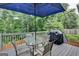 Deck with table, chairs, umbrella, and grill at 770 Dunagan Forest Dr, Lawrenceville, GA 30045