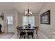 Charming dining room with a round table and six chairs, complemented by natural light at 770 Dunagan Forest Dr, Lawrenceville, GA 30045