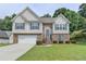 Two-story house with stone accents, a two-car garage, and a well-manicured lawn at 770 Dunagan Forest Dr, Lawrenceville, GA 30045