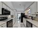 Clean and functional kitchen with white cabinets and black appliances at 770 Dunagan Forest Dr, Lawrenceville, GA 30045