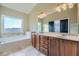 Large Primary bathroom with a soaking tub, double vanity, and neutral color scheme at 9972 Ashton Old Rd, Douglasville, GA 30135