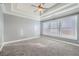 Bright bedroom with tray ceiling and carpet flooring at 9972 Ashton Old Rd, Douglasville, GA 30135