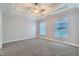 Well-lit bedroom with tray ceiling and carpet flooring at 9972 Ashton Old Rd, Douglasville, GA 30135