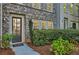 Townhouse front door with brick exterior and landscaping at 9972 Ashton Old Rd, Douglasville, GA 30135